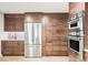 Modern kitchen featuring stainless steel appliances, wood cabinets, a refrigerator and ample storage space at 1 Winged Foot Way, Littleton, CO 80123