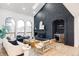 Bright living room with vaulted ceiling, dark brick fireplace, and stylish furnishings at 1 Winged Foot Way, Littleton, CO 80123