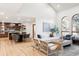 Open-concept living space with hardwood floors, ample seating, and a modern kitchen at 1 Winged Foot Way, Littleton, CO 80123