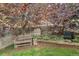 Serene backyard with wooden bench, lush greenery, and a charming wooden fence at 6731 E 128Th Pl, Thornton, CO 80602