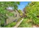 Charming backyard featuring a lush lawn, vibrant foliage, and a well-maintained exterior at 6731 E 128Th Pl, Thornton, CO 80602