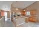 Bright kitchen with stainless steel appliances, tile island, light wood cabinets, and hardwood floors at 6731 E 128Th Pl, Thornton, CO 80602