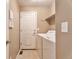 Bright laundry room featuring a washing machine and dryer with tile flooring and a utility sink at 6731 E 128Th Pl, Thornton, CO 80602
