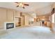 Open-concept living room featuring a fireplace, high ceilings, and seamless access to the kitchen at 6731 E 128Th Pl, Thornton, CO 80602