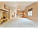 Spacious living room featuring a fireplace, vaulted ceilings, and an open view to the kitchen at 6731 E 128Th Pl, Thornton, CO 80602