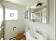 This bathroom features a glass enclosed shower, a square glass block window, and a white toilet and vanity at 1075 S Ames St, Lakewood, CO 80226