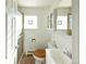 This bathroom features a glass enclosed shower, a square glass block window, and a white toilet and vanity at 1075 S Ames St, Lakewood, CO 80226