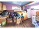 This bedroom has purple walls, a blue ceiling, wood floors, and is filled with boxes and clutter at 1075 S Ames St, Lakewood, CO 80226