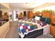 Bedroom with carpet, large bed with patterned quilt, wooden furniture and decorative plants on the headboard at 1075 S Ames St, Lakewood, CO 80226