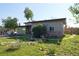 Charming exterior elevation showcasing a unique design with stone accents and a well-maintained front yard at 1075 S Ames St, Lakewood, CO 80226