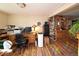 Functional home office with hardwood floors, desk space, storage, and natural light at 1075 S Ames St, Lakewood, CO 80226