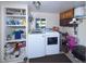Laundry room with washer, dryer, storage shelves, and cabinet space at 1075 S Ames St, Lakewood, CO 80226