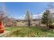 Sprawling backyard offering well-maintained grass, lovely neighborhood views, and mature trees at 1122 Orion Way, Castle Rock, CO 80108