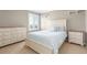 Cozy bedroom with a queen bed, dresser, nightstand, neutral walls, and white trim at 1122 Orion Way, Castle Rock, CO 80108