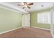 Spacious bedroom with carpet, green painted walls, white trim, and a large window at 1122 Orion Way, Castle Rock, CO 80108