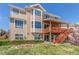 Multi-story home featuring a covered deck, well-kept lawn, and lush landscaping at 1122 Orion Way, Castle Rock, CO 80108