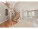 Grand foyer showcasing a beautiful staircase, hardwood floors, and soaring ceilings at 1122 Orion Way, Castle Rock, CO 80108