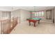 Spacious game room featuring a pool table, carpeted flooring, and natural light from a large window at 1122 Orion Way, Castle Rock, CO 80108