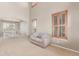 Open-concept living room with large windows, neutral decor, and seamless flow to dining area at 1122 Orion Way, Castle Rock, CO 80108