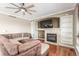 Cozy living room boasts a fireplace, built-in shelves, hardwood floors, and a ceiling fan at 1122 Orion Way, Castle Rock, CO 80108