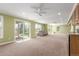 Spacious living room featuring a walkout patio, carpeted floor, and abundant natural light at 1122 Orion Way, Castle Rock, CO 80108