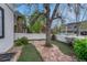 Landscaped backyard featuring a brick path and mature trees, providing a serene outdoor space at 520 Columbine St, Denver, CO 80206
