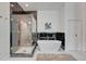 Modern bathroom featuring a soaking tub, glass shower and marble accents at 520 Columbine St, Denver, CO 80206