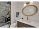 Modern bathroom features a sleek vanity, an oval mirror, designer shower, and contemporary fixtures at 520 Columbine St, Denver, CO 80206
