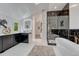 Modern bathroom with black and white marble shower, soaking tub, and double sink vanity at 520 Columbine St, Denver, CO 80206