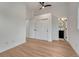 Bedroom featuring wood floors, a ceiling fan, and a sliding closet with access to ensuite at 520 Columbine St, Denver, CO 80206