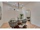 Bright dining area features a glass table with unique chairs, modern lighting, and a cowhide rug at 520 Columbine St, Denver, CO 80206
