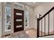 Inviting foyer with modern wood door, sidelight windows, and a patterned rug on the light hardwood floor at 520 Columbine St, Denver, CO 80206