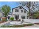 Stunning two-story home showcasing modern design with white stucco and contrasting dark trim, a landscaped yard, and a welcoming walkway at 520 Columbine St, Denver, CO 80206