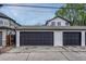 Detached three car garage with modern doors and ample parking space on a concrete driveway at 520 Columbine St, Denver, CO 80206