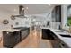 Open floor plan kitchen featuring modern appliances, black cabinets, and seamless flow into living spaces at 520 Columbine St, Denver, CO 80206