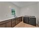A spacious laundry room has dark cabinets, granite countertops and modern washer and dryer at 520 Columbine St, Denver, CO 80206