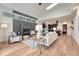 Open-concept living room with sleek fireplace adjoins kitchen, features hardwood floors and natural light at 520 Columbine St, Denver, CO 80206