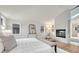 Spacious and bright main bedroom with a fireplace, light wood floors and plenty of light at 520 Columbine St, Denver, CO 80206