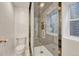 Modern shower featuring sleek marble walls, glass door, and bright natural lighting at 520 Columbine St, Denver, CO 80206