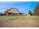 Expansive backyard featuring a deck, covered patio, and storage shed at 6298 S Harlan Way, Littleton, CO 80123