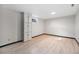 Finished basement with wood look flooring and storage cabinets at 6298 S Harlan Way, Littleton, CO 80123