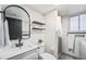 Bathroom with white vanity, shower stall, and floating shelves at 6298 S Harlan Way, Littleton, CO 80123