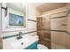 Bathroom with large shower and a blue vanity with lots of counter space at 6298 S Harlan Way, Littleton, CO 80123