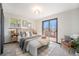 Well-lit bedroom with large sliding glass doors leading to an outdoor deck at 6298 S Harlan Way, Littleton, CO 80123