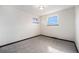 A vacant bedroom painted white features two windows and neutral carpeting at 6298 S Harlan Way, Littleton, CO 80123
