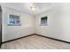 Vacant bedroom with hardwood floors and two windows at 6298 S Harlan Way, Littleton, CO 80123