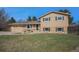 Charming two-story home with a well-maintained lawn and attached two car garage at 6298 S Harlan Way, Littleton, CO 80123