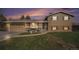 Beautiful two-story home with an attached two car garage under a colorful sunset at 6298 S Harlan Way, Littleton, CO 80123