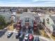 Aerial view shows complex's architectural details, parking, and landscaping at 970 S Dawson Way # 15, Aurora, CO 80012