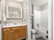 Functional bathroom featuring a shower, toilet, vanity with neutral tones, and a mirrored medicine cabinet at 970 S Dawson Way # 15, Aurora, CO 80012